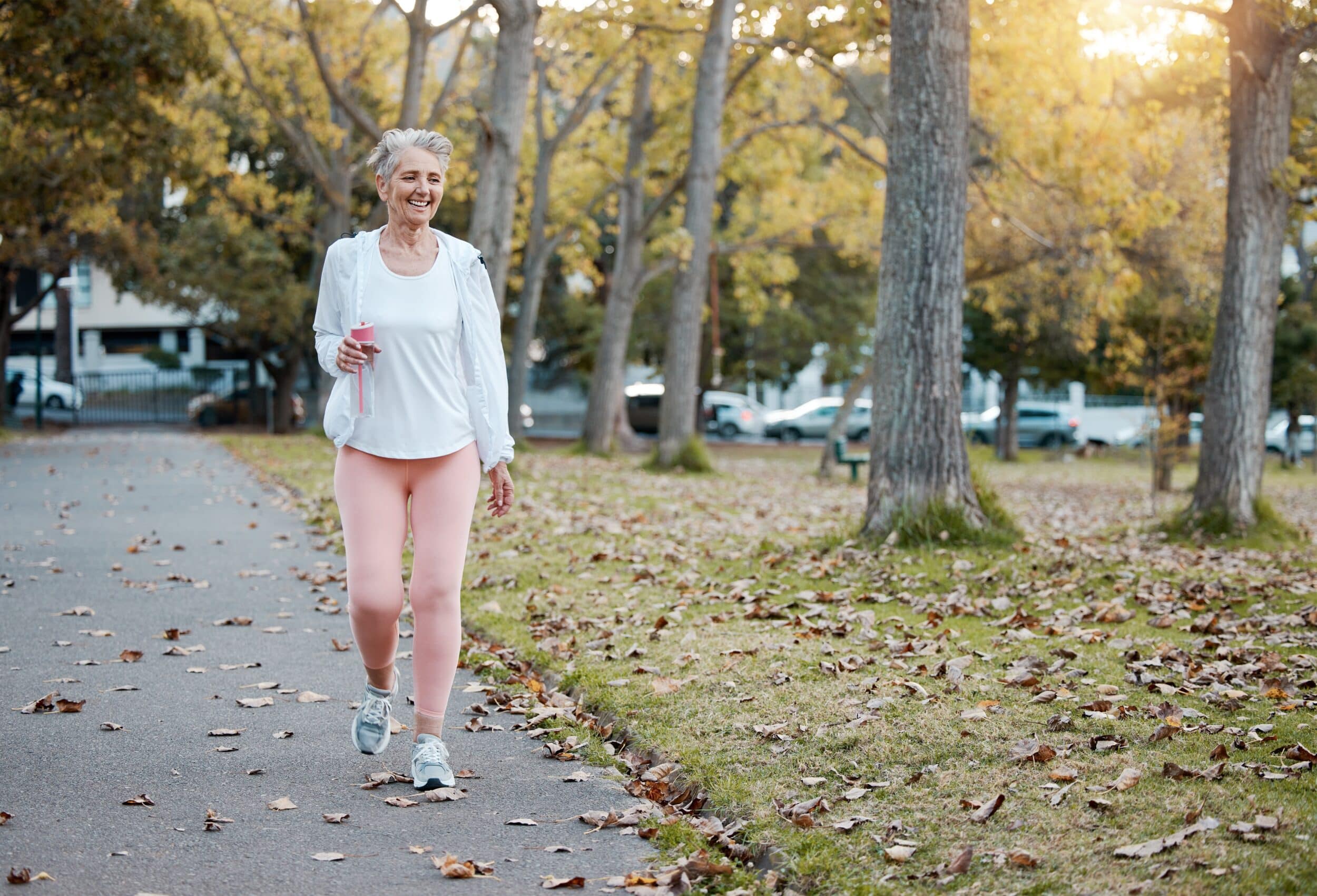 Woman smiles brightly as she walks to reduce varicose vein pain
